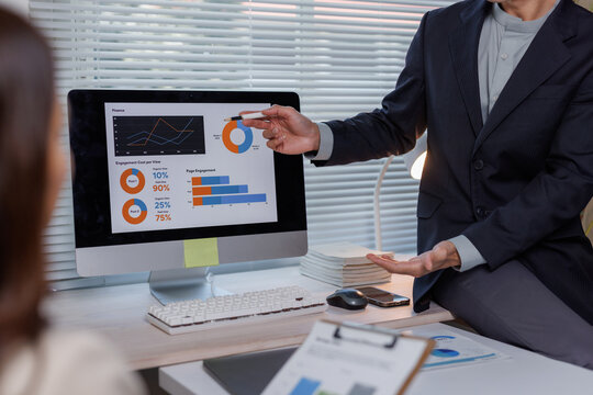 Business person sharing data analysis insights on monitor screen