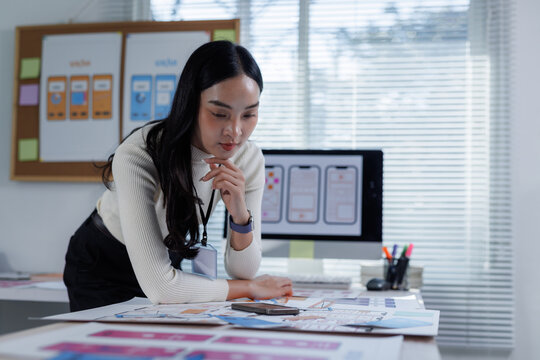 Woman designer brainstorming app user interface wireframes