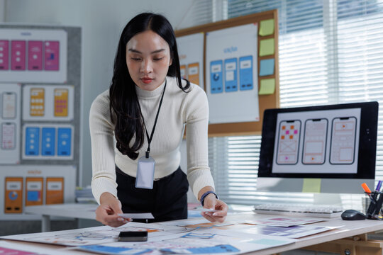 Woman actively designing mobile application interface prototypes