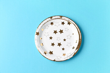 Paper disposable plate on blue background