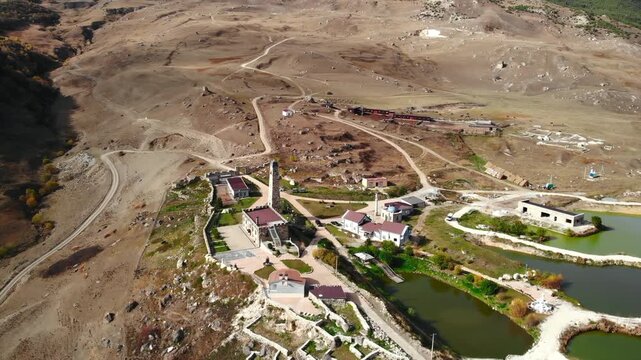 Aerial view of tillo castle and village in a mountainous landscape. Media