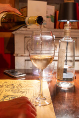 Drinking of white wine in restaurant for dinner, glasses of white wine in Italy, France, European lifestyle