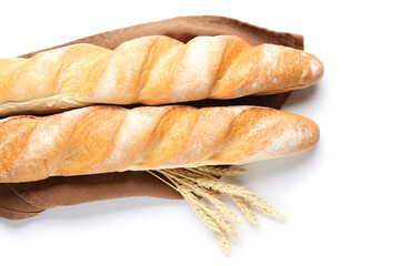 Fresh baguettes and wheat on white background