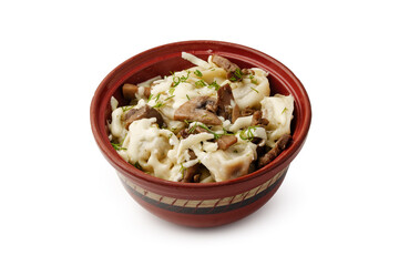 Delicious pasta dish with mushrooms and herbs served in a traditional bowl