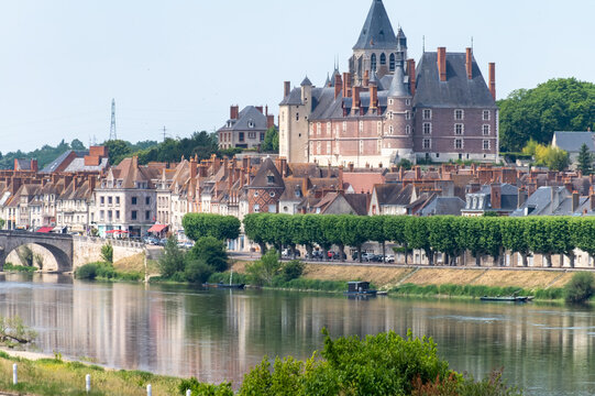 Views of old part of town of Gien on the Loire river, in Loiret department, France, houses with tiled roofs and chimneys, castle and bridge