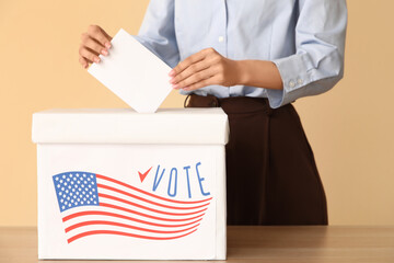 Voting woman near ballot box with USA flag on beige background