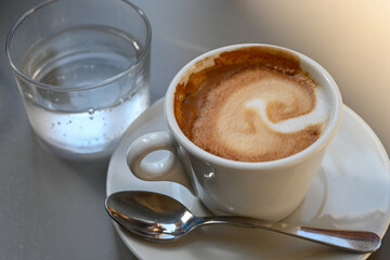 Drinking of italian coffee cappuccino served in museum and castle cafe in Milan, Italy