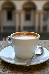 Drinking of italian coffee cappuccino served in museum and castle cafe in Milan, Italy