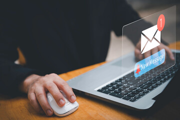 Businessman touching new message notification icon on virtual screen,email alert, online messaging system, representing digital communication, instant response, and business connectivity.