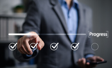 Businessman using check mark on checklist with progressive loading status to remind work in...
