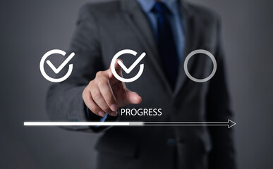 Businessman using check mark on checklist with progressive loading status to remind work in progress for project development management and idea tracking.
