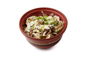 Delicious pasta dish served in a rustic bowl topped with herbs and creamy sauce