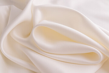 large soft waves of cream satin fabric. Wedding satin background beige, cream color. layout for...
