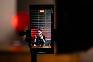 The man is setting up his equipment for a podcast recording session