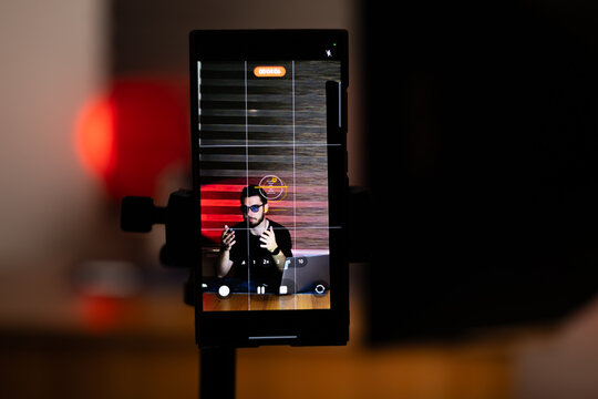 The man is setting up his equipment for a podcast recording session