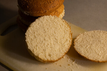 Slicing burger bun close up on kitchen counter