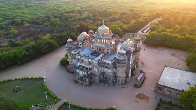 Aerial view of Vijay Vilas Palace in Mandvi, Kutch, Gujarat, India, showcasing its magnificent royal architecture, domes, balconies, and lush green surroundings. Stunning drone footage capturing the g