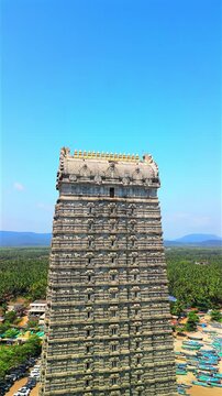 Aerial view of Murdeshwar Temple in Karnataka, India, showcasing the magnificent Shiva statue, temple complex, and coastal landscape along the Arabian Sea. Stunning drone footage captures the towering