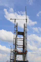 Construction of High-Rise Structural Framework of Cable Stayed Tower Bridge with Tower Cranes