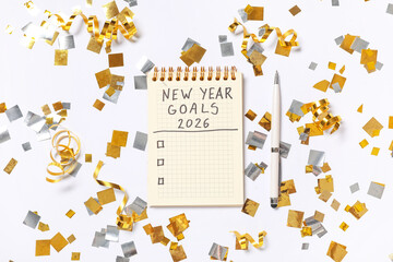 Notebook with empty to do list, pen and confetti on white background. New Year Goals 2026