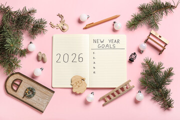 Obraz premium Notebook with empty to do list, pen and Christmas decor on pink background. New Year Goals 2026