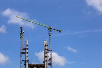 Construction of High-Rise Structural Framework of Cable Stayed Tower Bridge with Tower Cranes