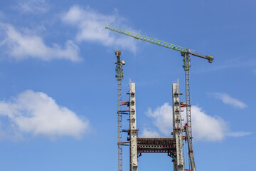 Construction of High-Rise Structural Framework of Cable Stayed Tower Bridge with Tower Cranes