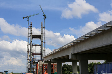 Construction of High-Rise Structural Framework of Cable Stayed Tower Bridge with Tower Cranes