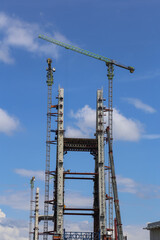 Construction of High-Rise Structural Framework of Cable Stayed Tower Bridge with Tower Cranes