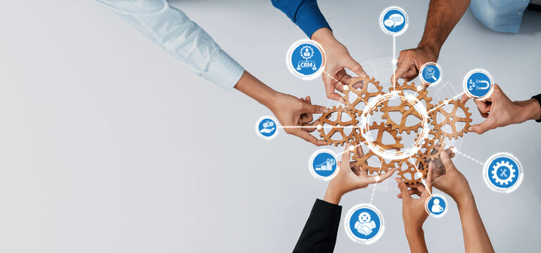 A dynamic image showcasing collaborative teamwork with hands joining around gears and icons, representing innovation, technology, and effective business management strategies. Amity
