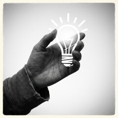Creative hand holds lightbulb representing innovative business solutions