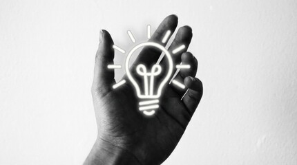 Creative hand holding glowing lightbulb idea for innovative solutions