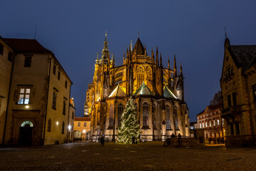 Fototapeta premium Christmas Tree Illuminated at Prague Castle During Winter Evening in UNESCO Historic Center with Festive Holiday Atmosphere