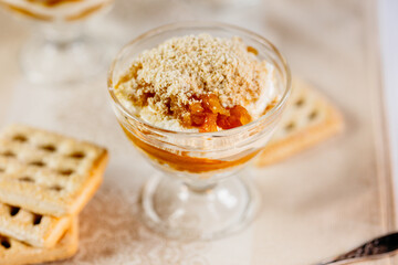 Set of three pumpkin cream cheese trifles in clear jars with cookie crumble, soft inviting look.