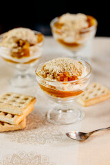 Pumpkin trifle trio in glass containers with cream cheese and cookie crumble, cozy homemade vibe.