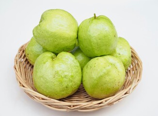 Several kimju guava are placed in a basket on a white background. They are healthy fruits and I grow them organiclly.