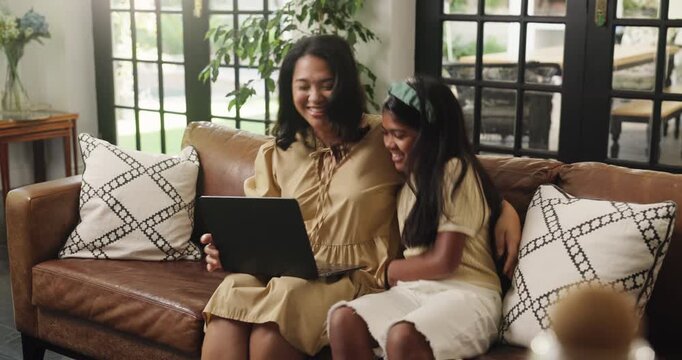 Laptop, happy and relax with mother and daughter on sofa for streaming service, movie choice and education show. Film subscription, bonding and online kids series with woman and child in family home