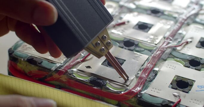 Spot welding nickel strips on a battery pack to improve electrical conductivity and durability.Adding a second nickel layer to reinforce the battery pack and enhance current flow.
