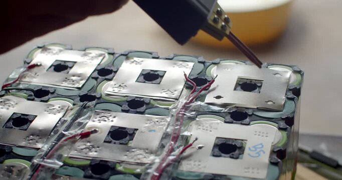 Spot welding nickel strips on a battery pack to improve electrical conductivity and durability.Adding a second nickel layer to reinforce the battery pack and enhance current flow.