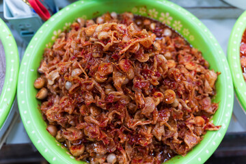 Spicy fermented Thai eggplants marinated with shredded galangal and red chili paste, a crunchy and savory traditional Hue side dish.