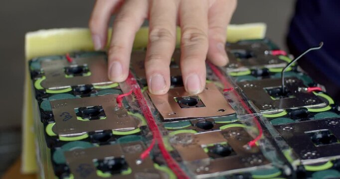Spot welding nickel strips on a battery pack to improve electrical conductivity and durability.Adding a second nickel layer to reinforce the battery pack and enhance current flow.