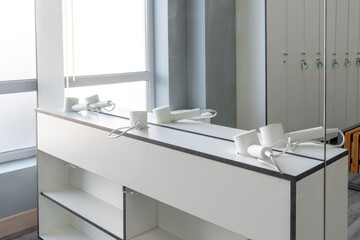Modern salon interior with hair dryers and bright natural light in a spacious room