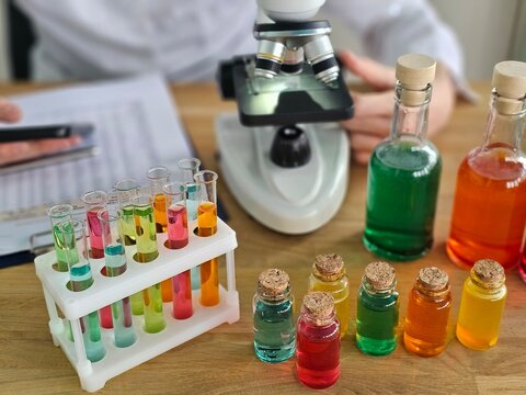 Colorful laboratory setup with various liquids and a microscope