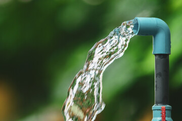 Fresh water flows from a pipe, highlighting the importance of the natural resource, showcasing clarity and purity