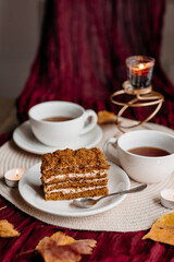 Rustic honey cake slice on a plate, warm tones highlighting its soft layers and inviting sweet texture.