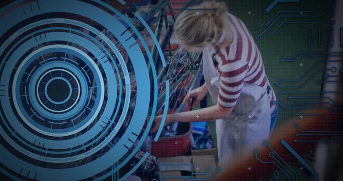 Female mechanic reaching into toolbox, tightening wheel bolts while blue HUD guiding repair