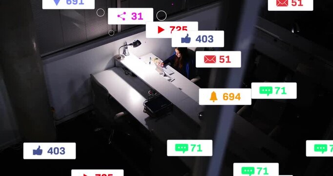 Lamp lighting desk, woman on social, tapping phone and laptop, notifications growing around her