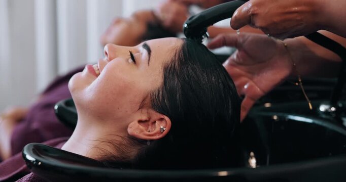 Happy woman, washing or hair with bowl in salon for grooming, spa or haircare treatment. Female person, customer and hairdresser cleaning with water or massage for keratin or service in beauty parlor