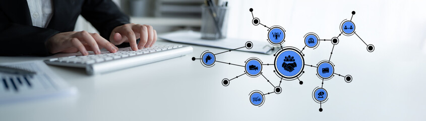Fototapeta premium A businessman works at a modern workspace with a keyboard and digital connection icons, symbolizing the integration of technology in business and networking. Tessel