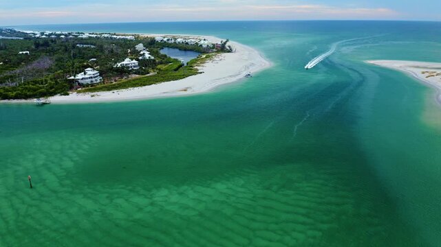 Sandbars and shifting teal water patterns define the entrance of Stump Pass as boats navigate the winding channel between Manasota Key and the outer shoreline along Florida&rsquo;s scenic Gulf Coast.
